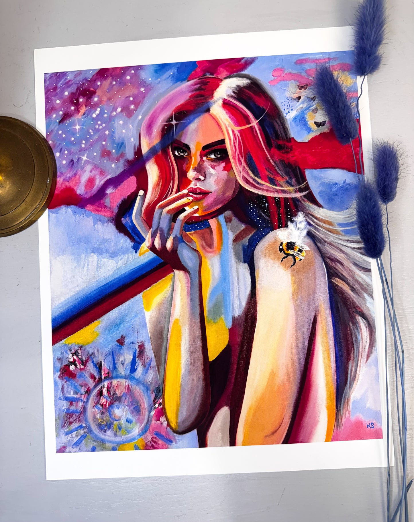 Colorful abstract painting of a woman with artistic elements on a white surface.