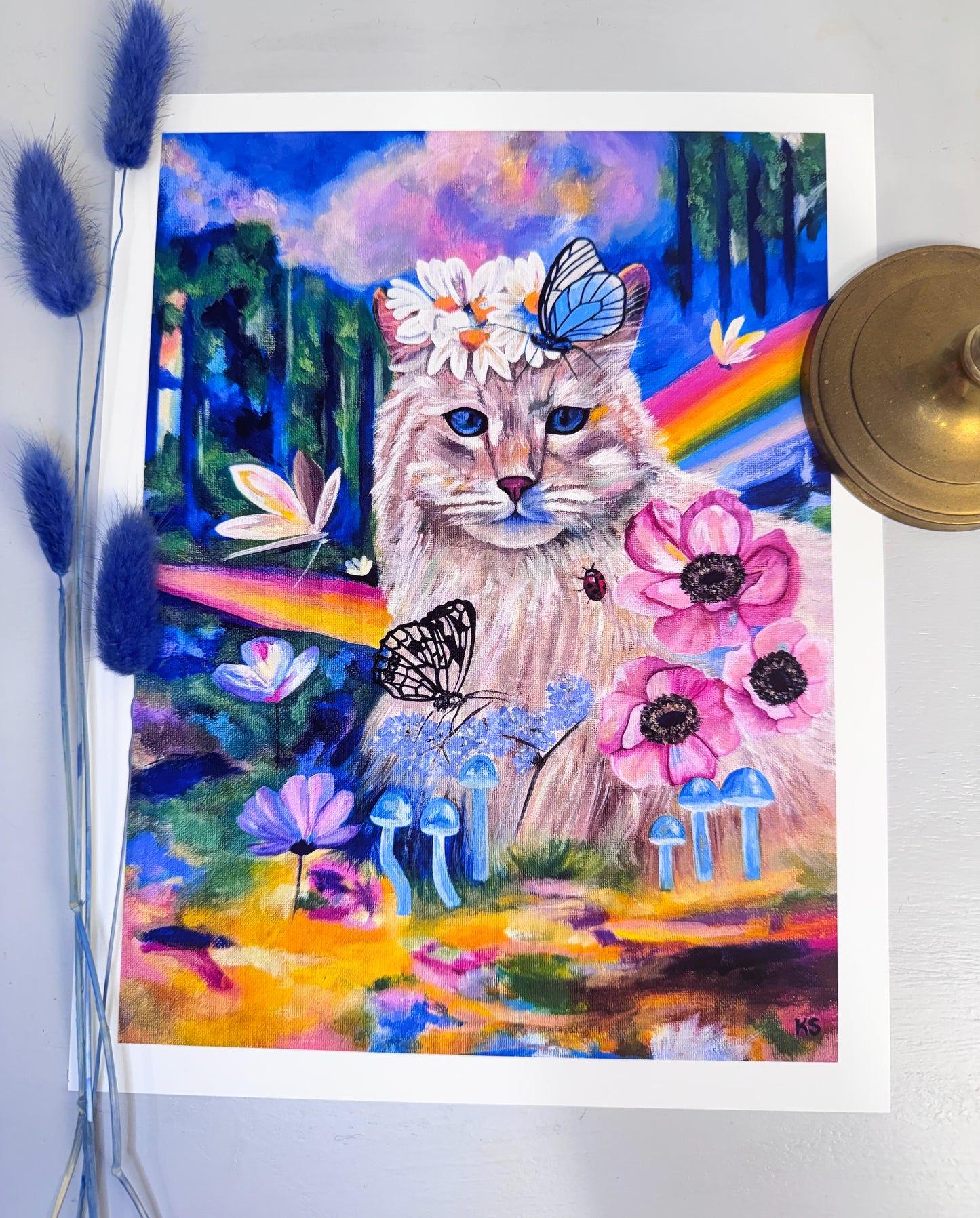 Colorful painting of a cat with flowers and butterflies on a white background
