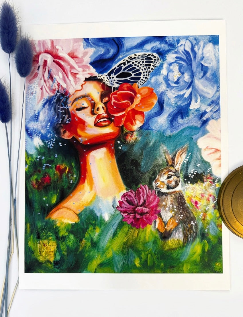 A picture of a print featuring. Woman, a butterfly, and a rabbit bunny. Green and blue