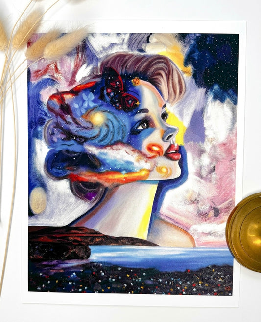 A print featuring a woman, a galaxy, a butterfly and a landscape