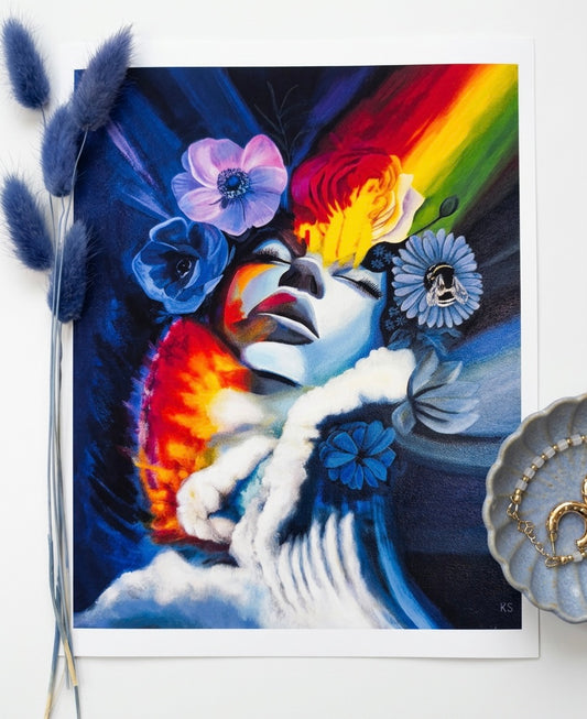 A print featuring a non binary face with flowers and a bee with a rainbow cutting through and a wave of water ocean