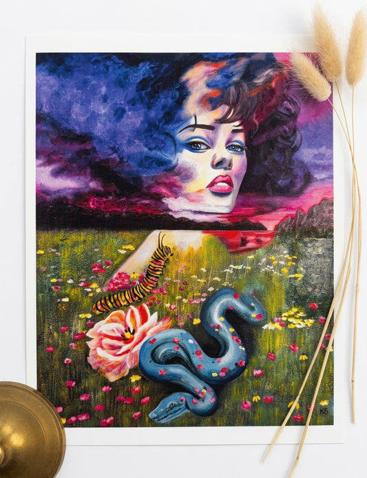 A print of a woman in a field with a colourful sky, a snake, a caterpillar and a flower