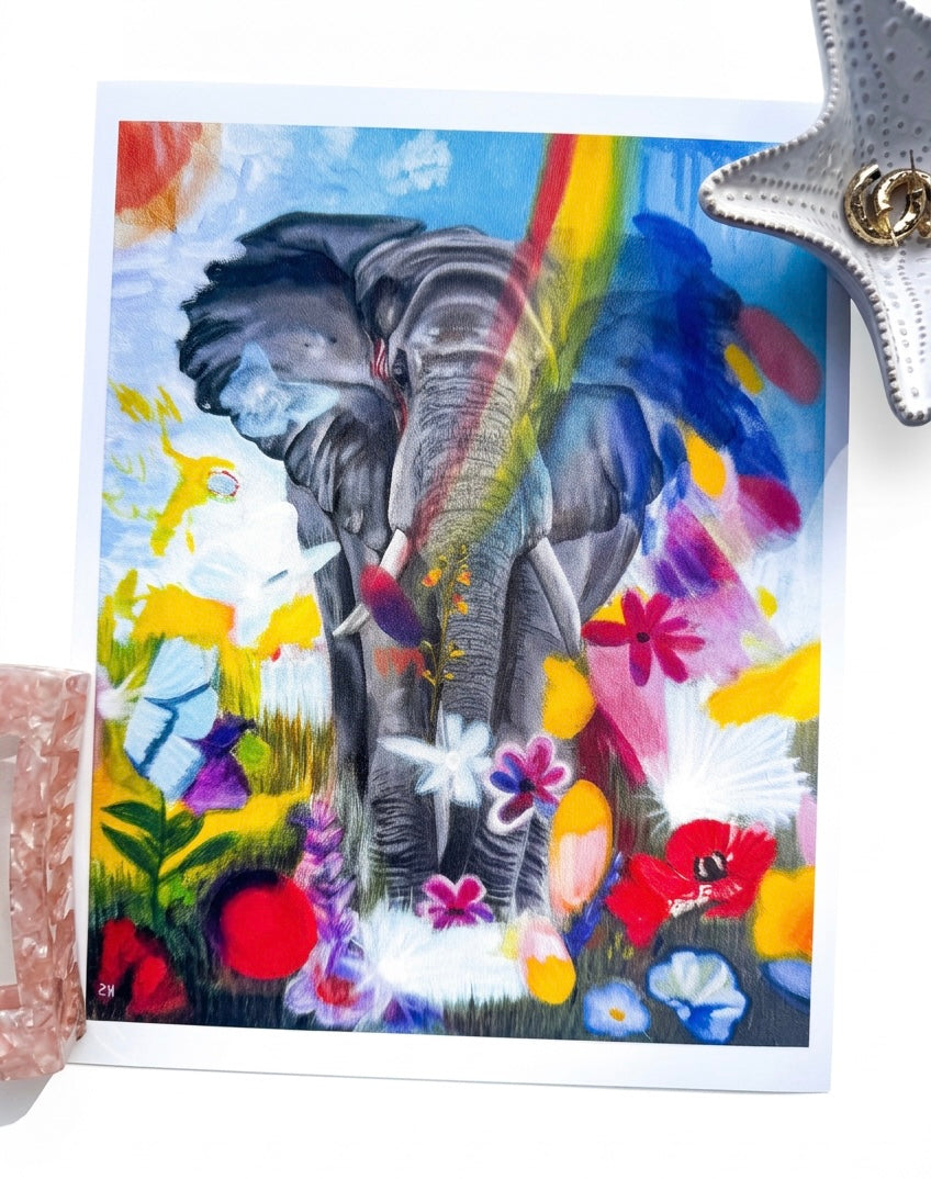 A print of an elephant surrounded by rainbows and flowers
