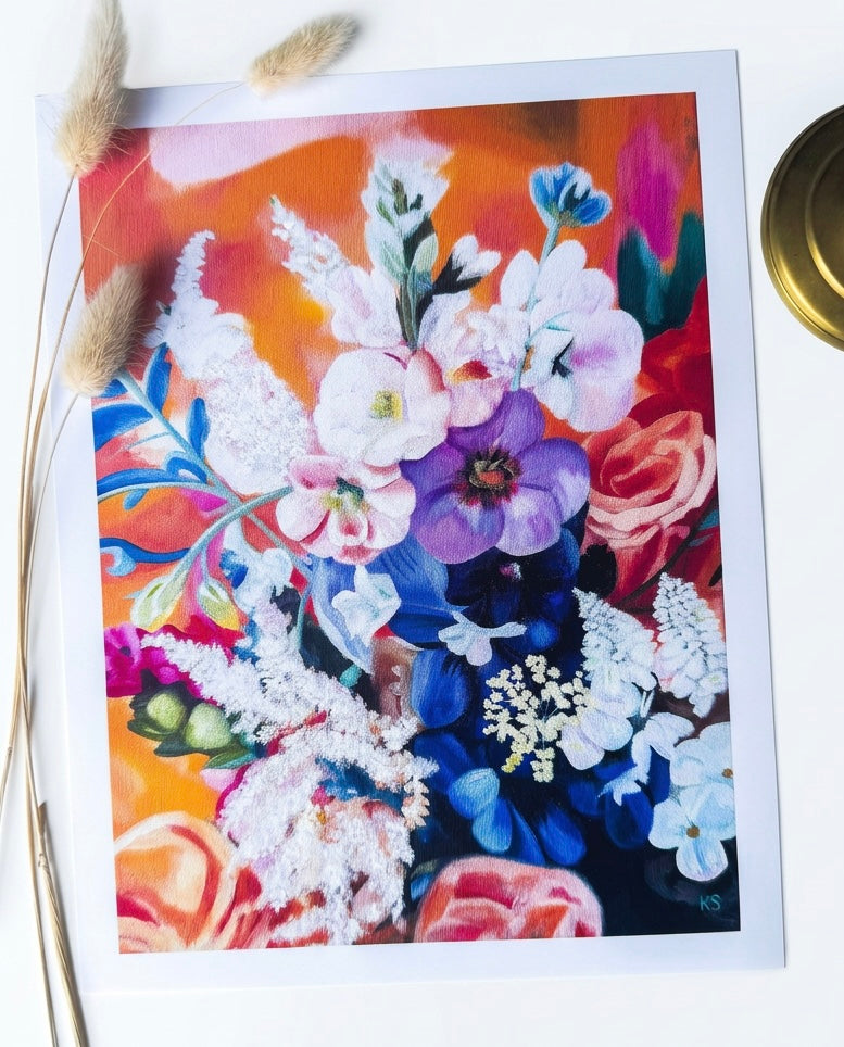 A print of a colourful floral arrangement with an orange background 