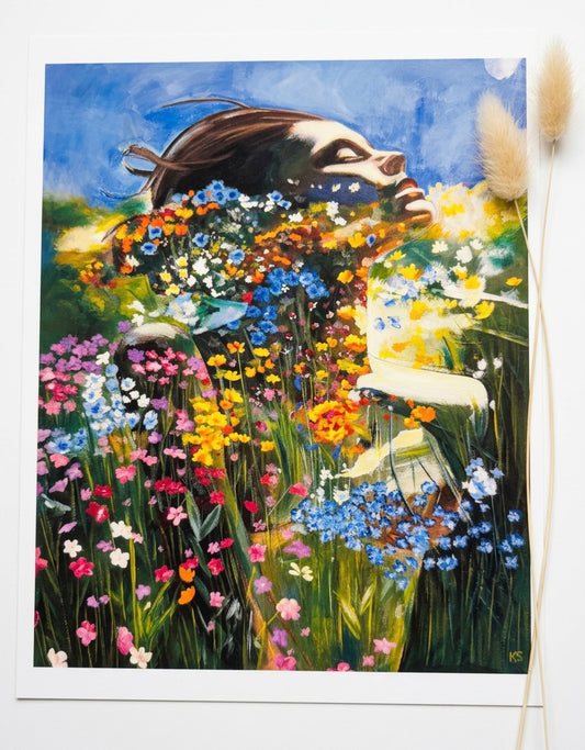 A print of a woman in a field of flowers.