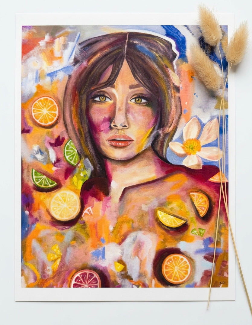 A print featuring a portrait of a woman surrounded by citrus