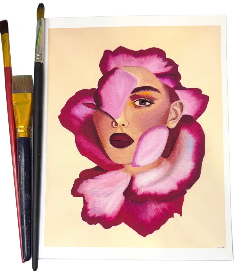 A print of a portrait of a woman’s face merged with a magenta flower against a creamy yellow background.