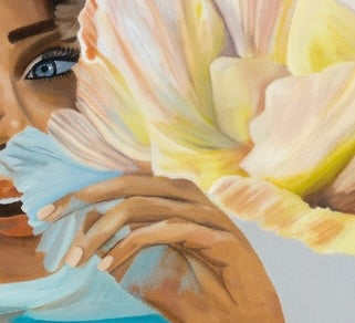 A close up of a painted woman against a gray background with a Large flower
