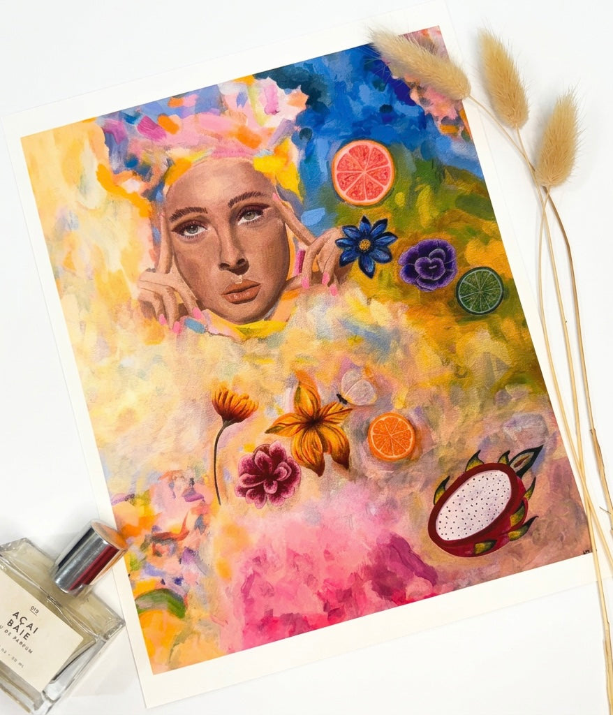 A print of a portrait of a woman surrounded by fruit, flowers and vibrant swatches of colourful paint
