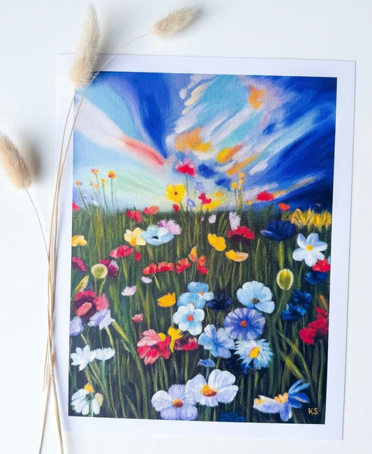 A print of a landscape with flowers and a colourful sky. Expressive and blue