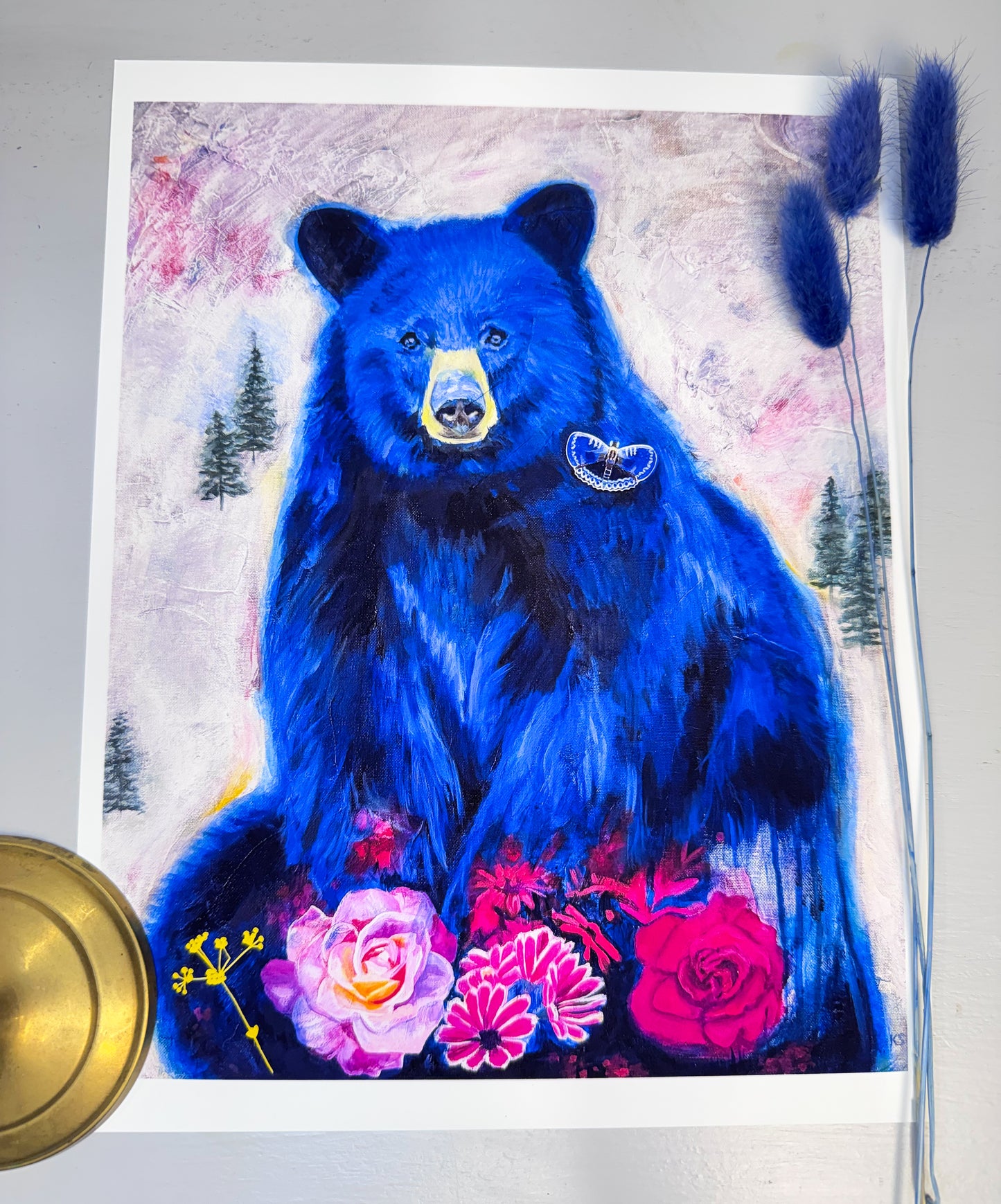 A Print of a blue bear with magenta flowers