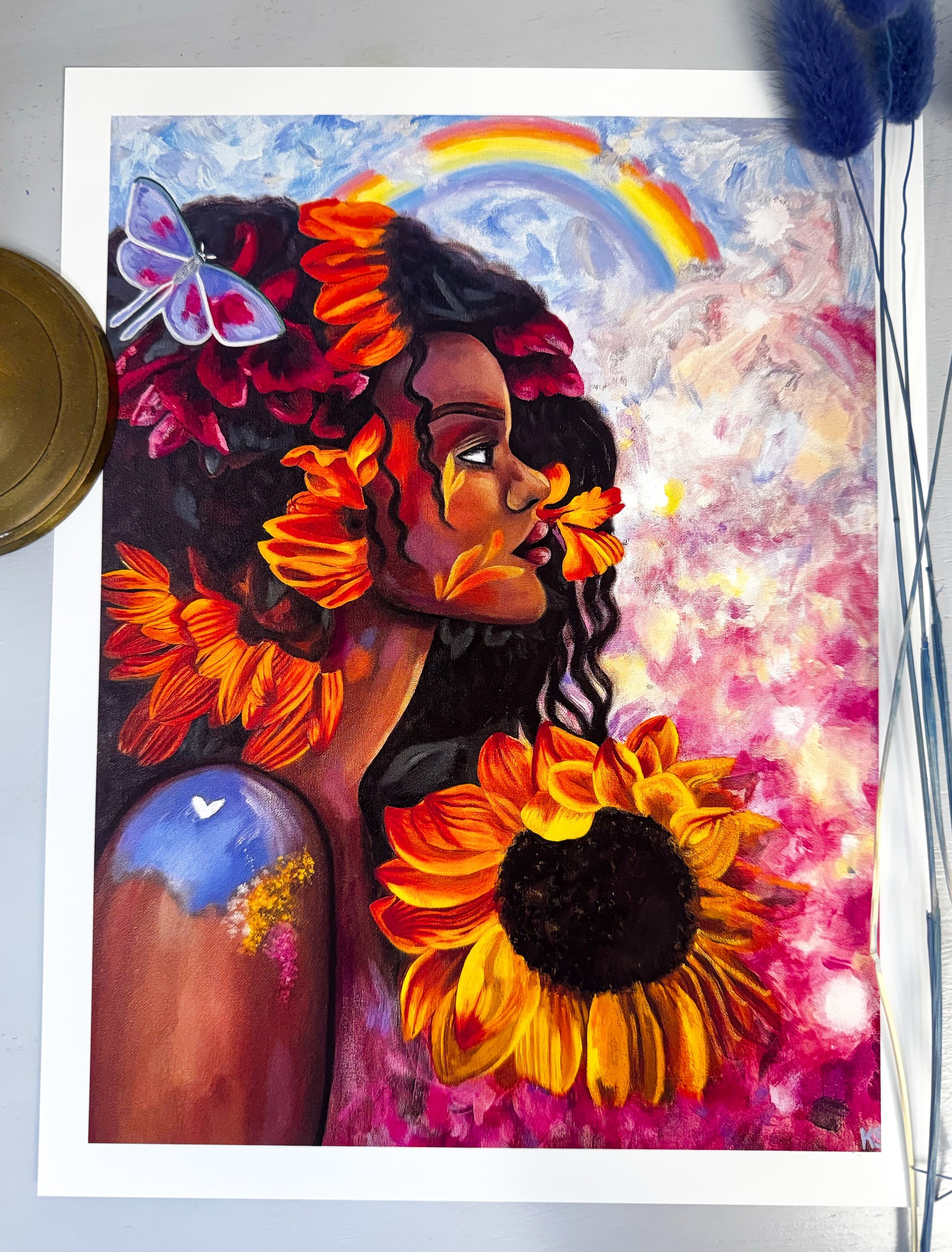 Artistic depiction of a woman with sunflowers and a rainbow in a colorful setting