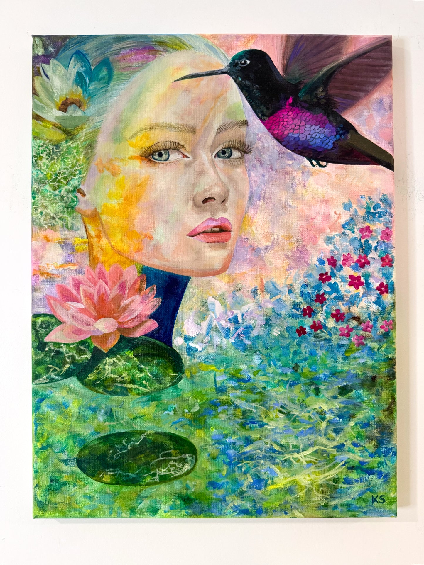 Artistic depiction of a woman's face with a hummingbird and floral elements