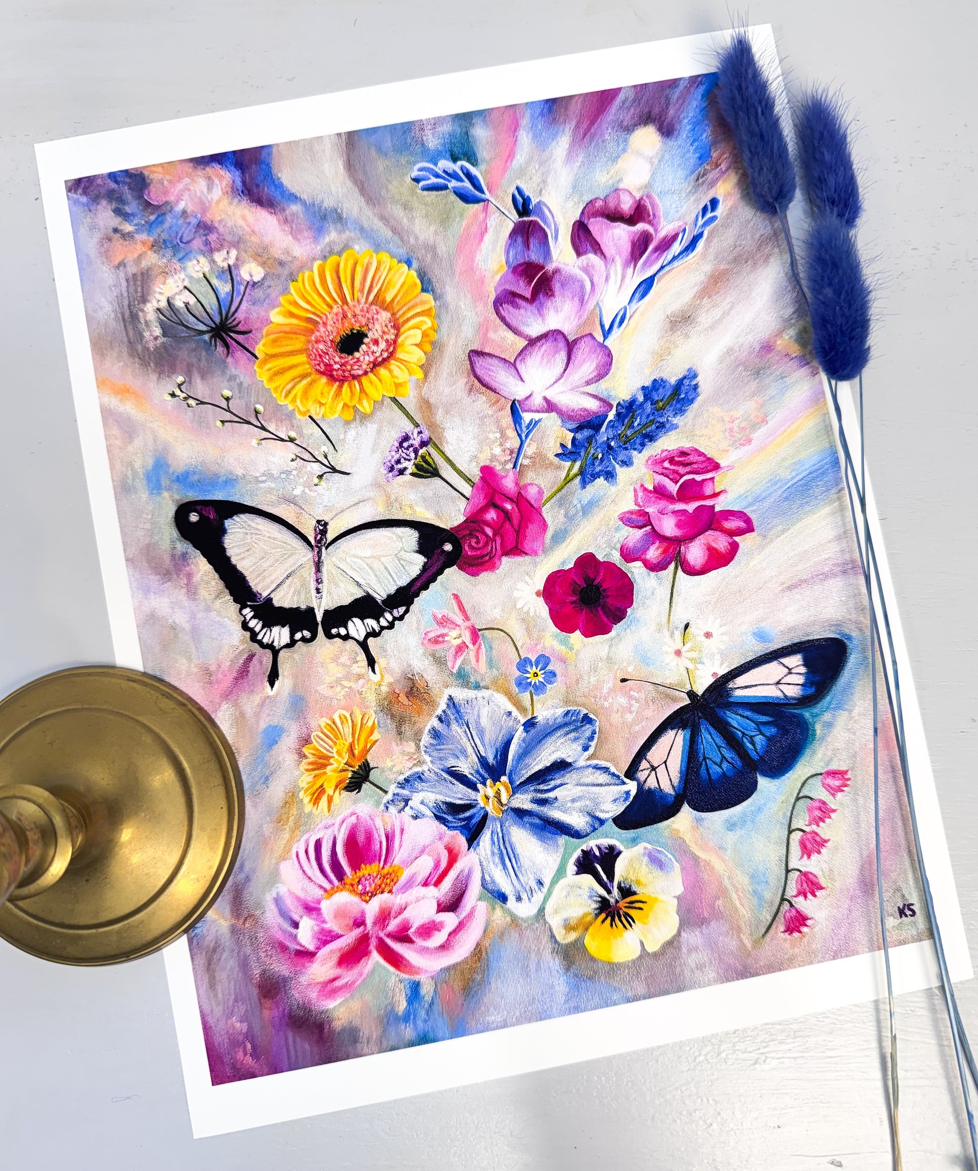A print featuring flowers and two butterflies against a opalescent background
