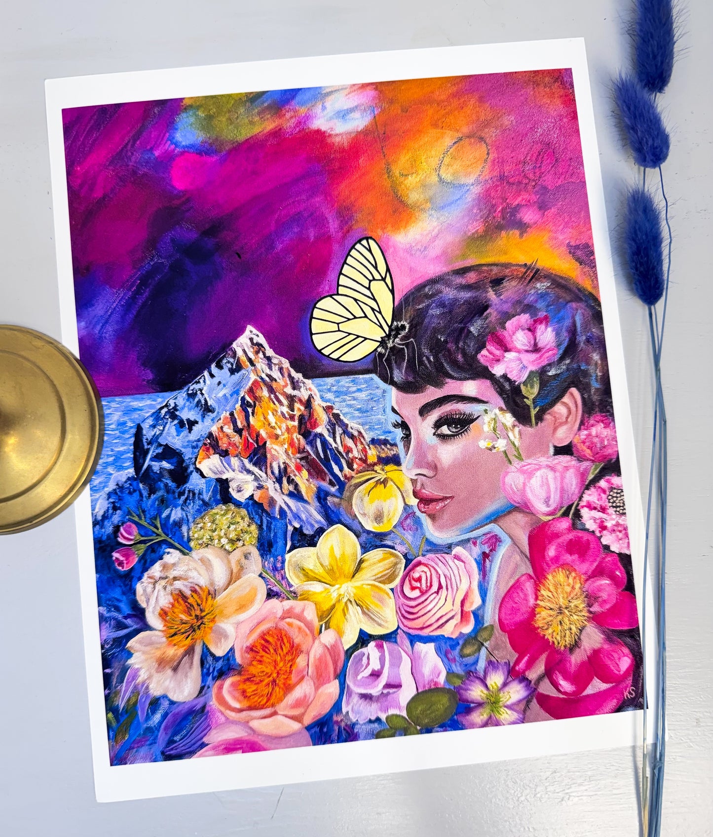 Colorful artwork of a woman with flowers and a butterfly on a white background