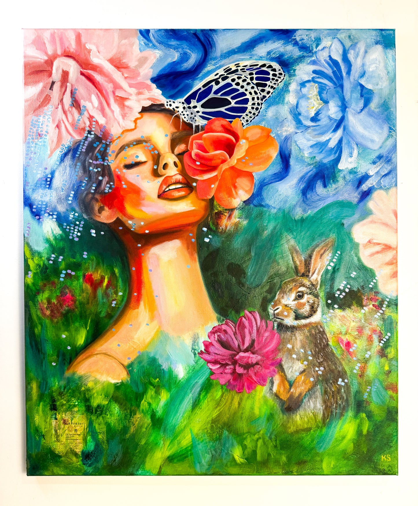 Colorful artwork of a woman with flowers and a rabbit in a garden setting