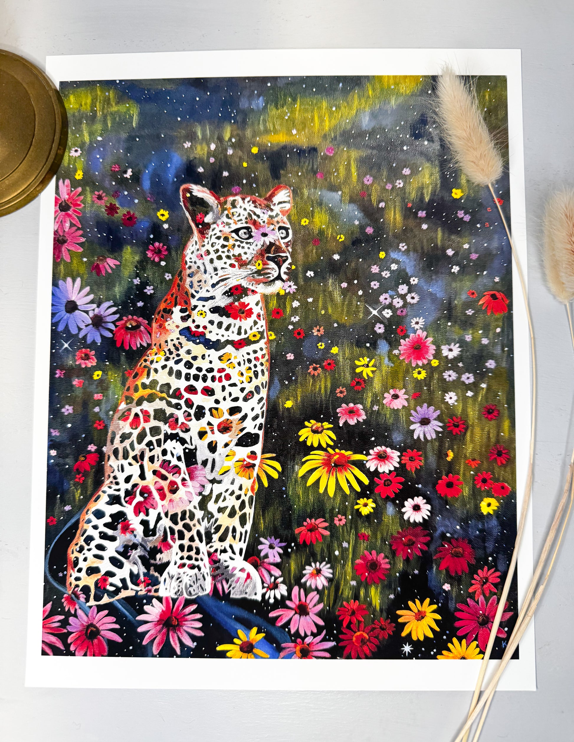 Colorful art print of a leopard surrounded by flowers and stars on a white background