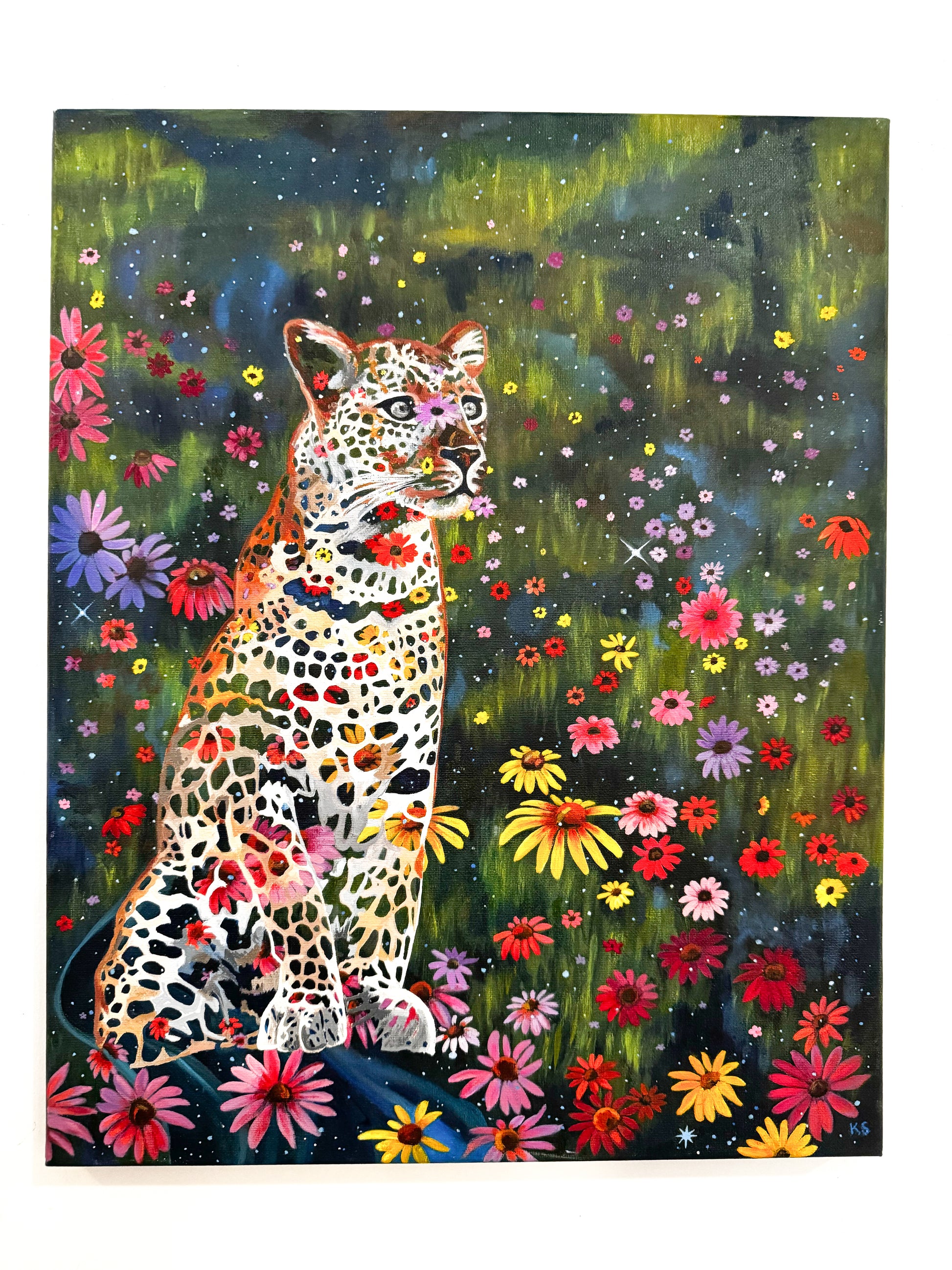 Colorful painting of a leopard surrounded by flowers and stars on a dark background