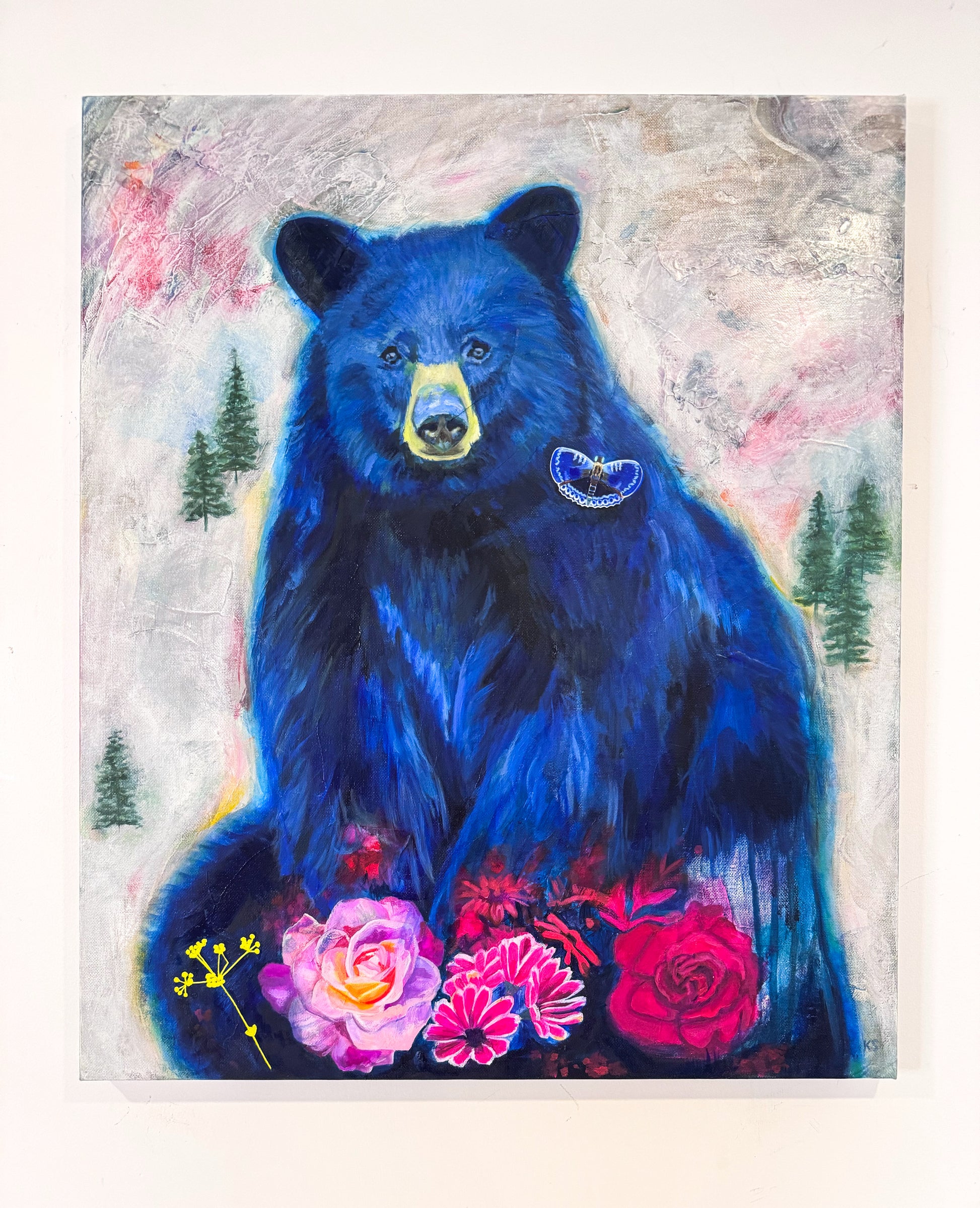 Painting of a blue bear with flowers and trees in the background