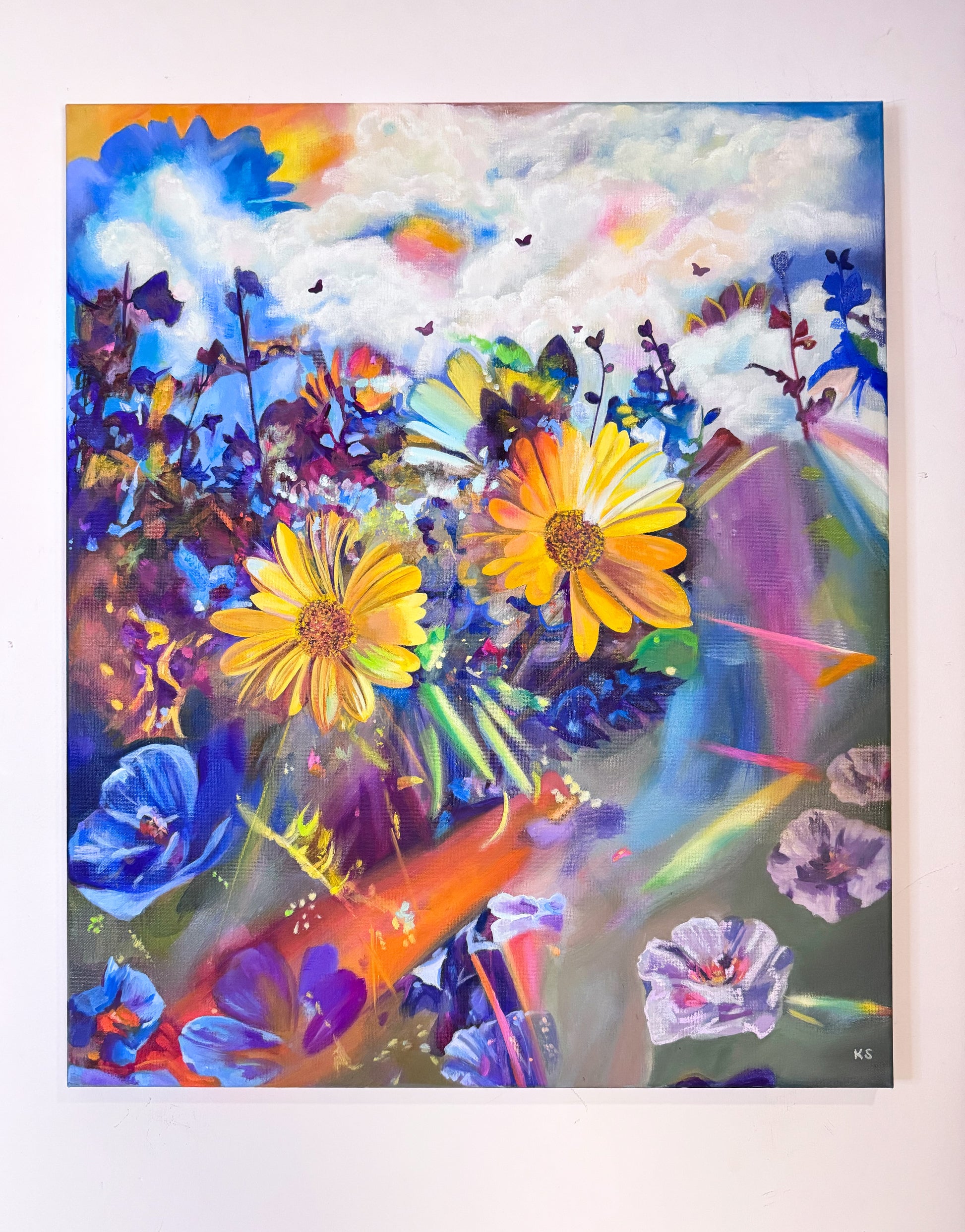 A painting of two flowers, against a sky with fluffy clouds, abstract swatches of paint and rainbow swatches of paint. 