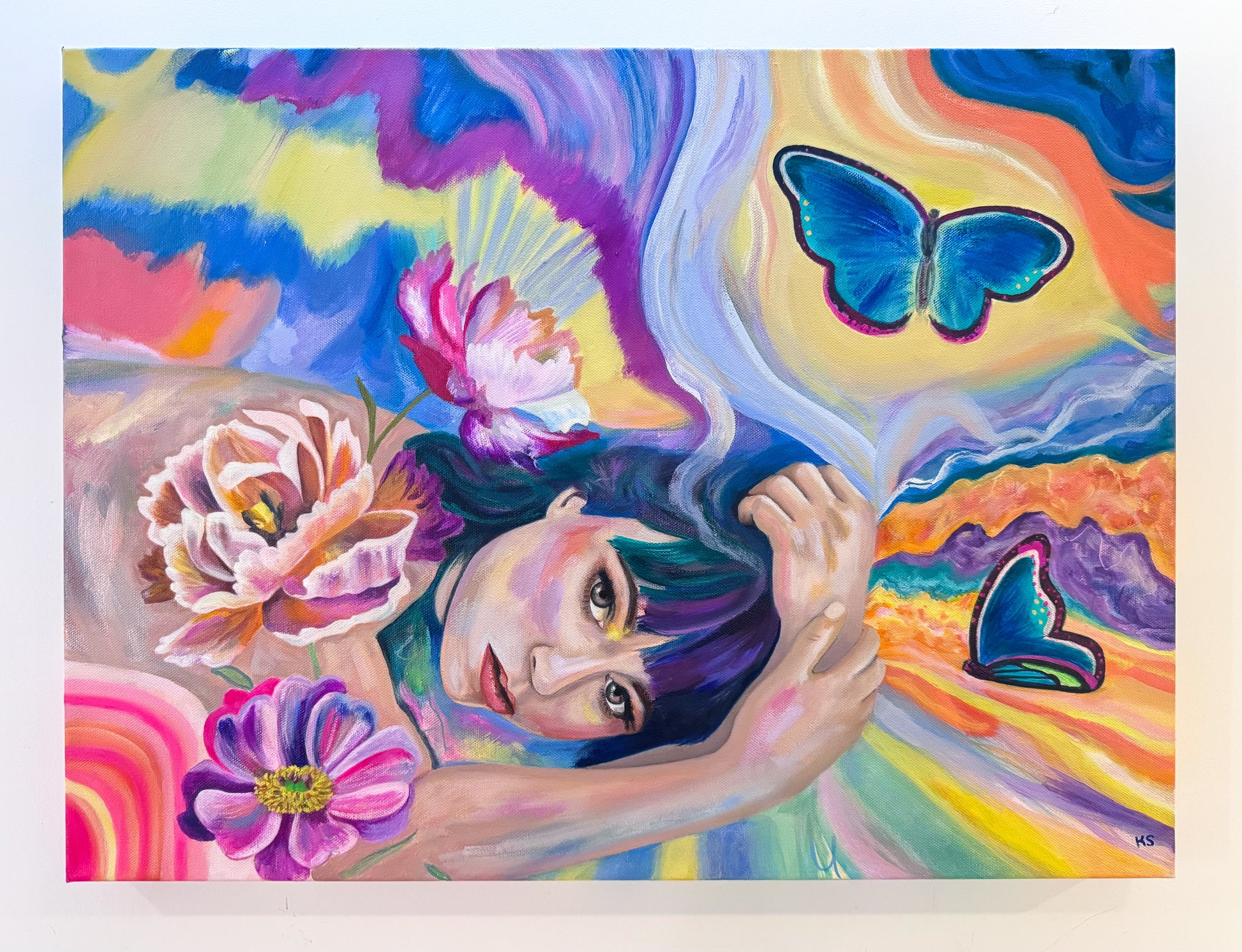 Painting of a woman posing surrounded by colourful paint, butterflies and flowers