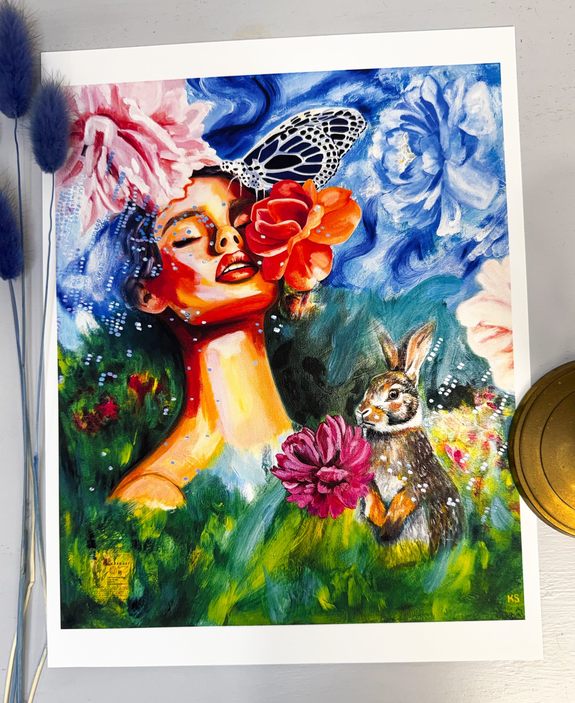 Colorful painting of a woman with flowers and a rabbit on a white background