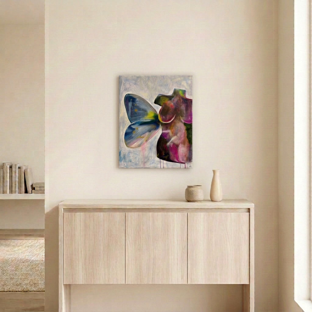 Torso Volume 5, a colourful female torso with a blue butterfly wing, displayed as an unframed canvas above a pale oak sideboard in a neutral room.
