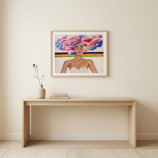 Landscape Head in the Clouds Print featuring a woman with colourful cloud hair and rainbow stripes, in a light wood frame above a pale wood console.