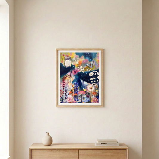 When The Hot Sun Burns Print, featuring colourful flowers, bees and a butterfly, in a slim light wood frame above a pale wood console.