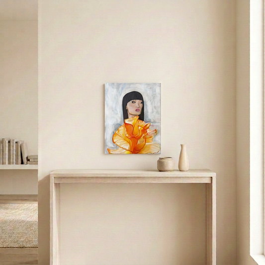 It’s Couture original painting of a woman with a black bob and orange floral dress, displayed unframed above a pale wood console in a neutral room.