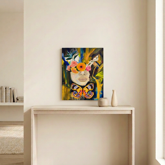 Still and Maximal, an unframed floral portrait with a colourful butterfly, displayed above a pale wood console in a neutral room.