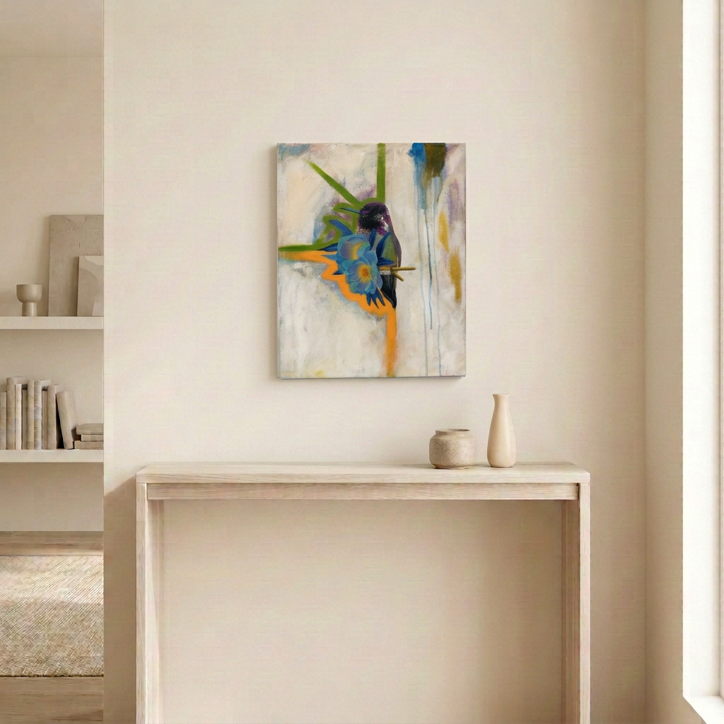 Hummingbird Love original painting displayed unframed above a pale wood console in a neutral room, featuring a hummingbird, blue flowers and colourful abstract strokes.