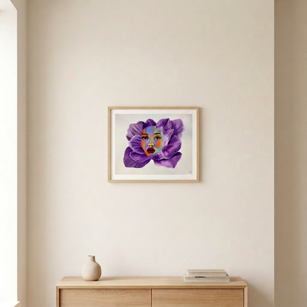 Fleur Forte Volume 4 Print, a colourful woman's face surrounded by purple petals, in a slim light wood frame above a pale wood console.