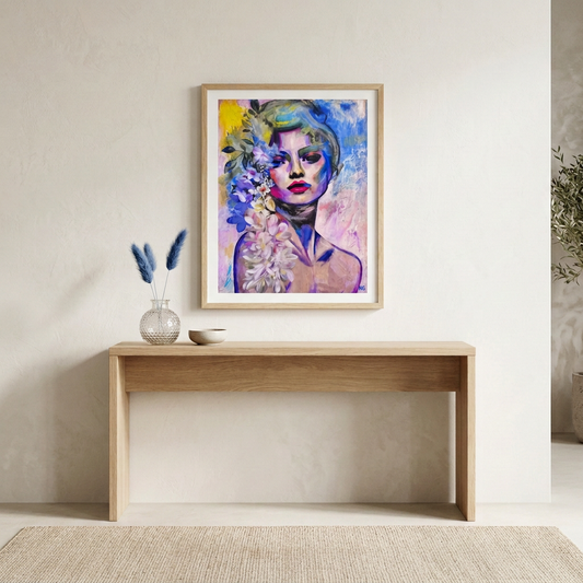 Wildflower Soul Print floral portrait in a light wood frame above an oak console, styled with blue dried stems in a glass vase and a small bowl in a neutral room.